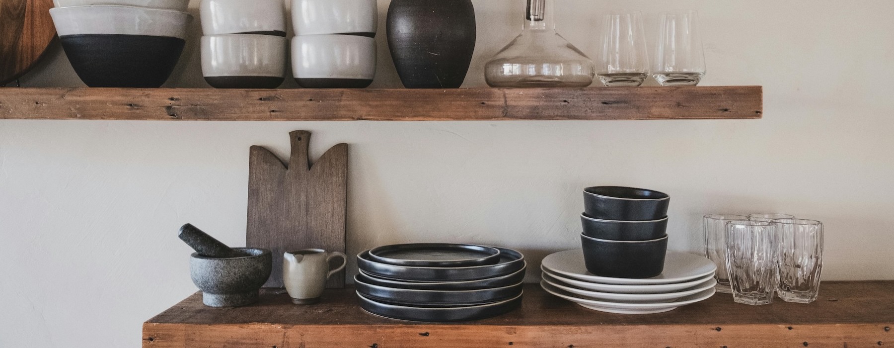 a shelf with dishes and glasses on it