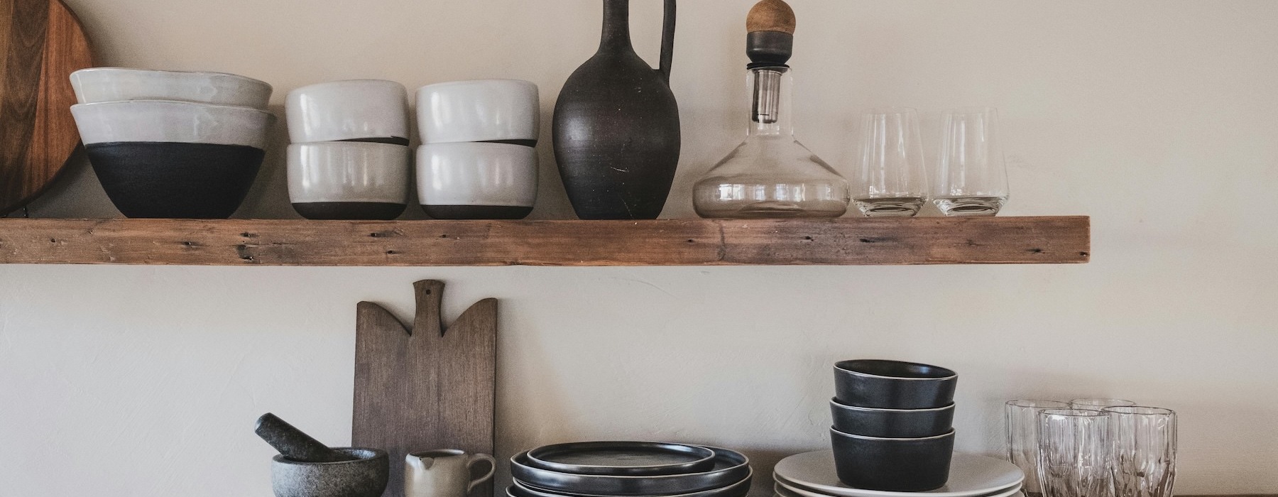 a shelf with dishes and glasses on it