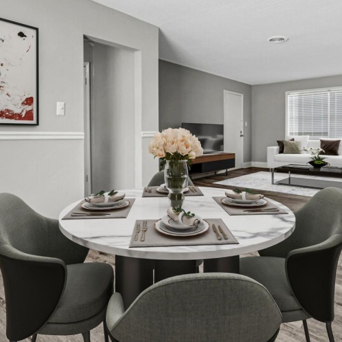 a living room with a table and chairs