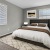 a bedroom with a bed and a lamp